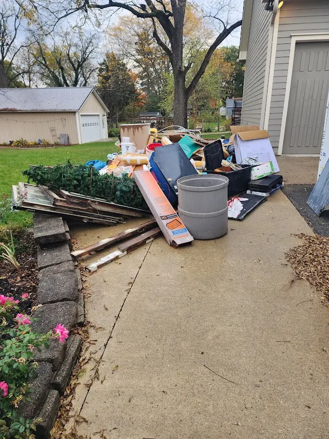 Dumpster being loaded with debris for 12 Yard Dumpster Rental in Baltimore Highlands